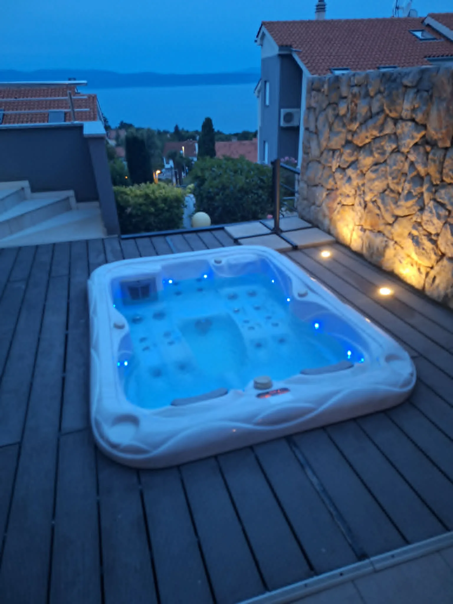 Private jacuzzi illuminated at dusk